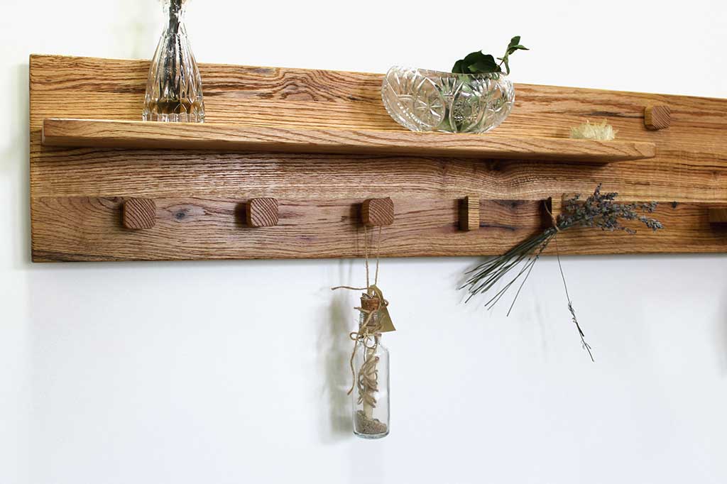 Hanging dry flowers and decorative items on wooden hooks