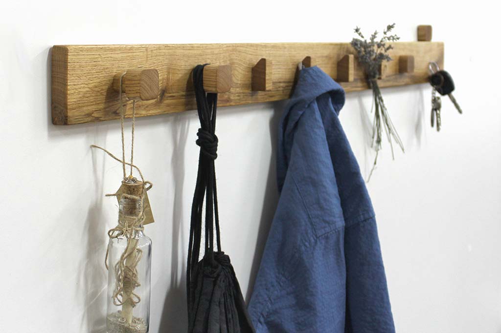 Close up of coat rack with wooden hook , it is  mounted on wall